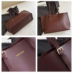 Detailed close-up of dark brown tote bag showing leather texture and golden metal buckle