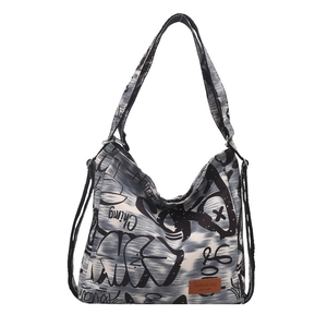 Women's large capacity canvas hobo bag with black street graffiti and brown leather patch