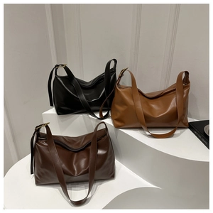Three minimalist large tote bags in black, caramel, and dark coffee with wide straps