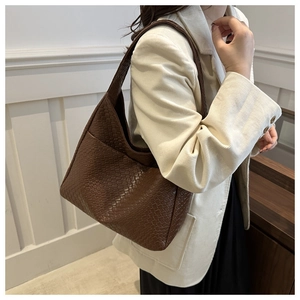 Detail of a dark brown woven hobo bag showing the high-quality checkerboard texture
