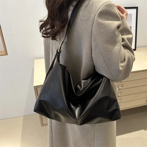 Minimalist black leather oversized hobo tote bag for daily commute and office wear