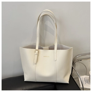 Close-up of beige tote bag with adjustable metal buckle and Fashion & Bags text print