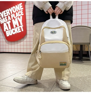Detail of a casual nylon backpack with contrasting cream and white canvas panels
