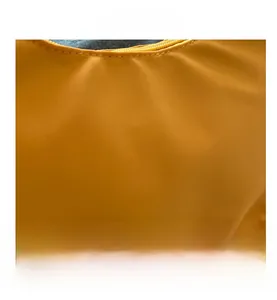 Close-up of yellow minimalist nylon shoulder bag showing neat stitching and zipper details