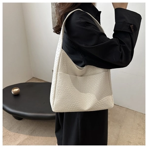 Detail of off-white hobo bag showing intricate woven texture and high-quality synthetic leather