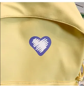 Detail shot of purple heart print on yellow fabric with visible stitching