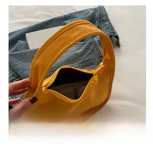 Detail view of bright yellow baguette bag interior showcasing daily storage capacity