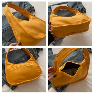 Detailed views of yellow nylon baguette bag showing the zipper pocket and interior space