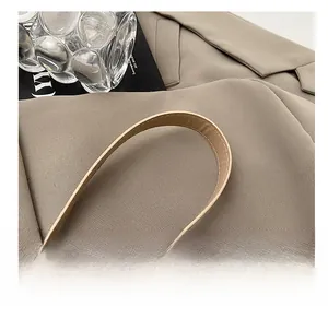 Detail of the khaki PU leather shoulder strap with premium white contrast stitching