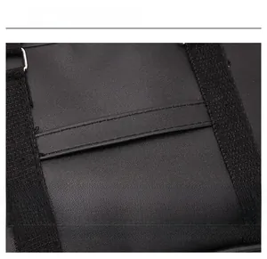 Close-up detail of the black leather texture and durable stitching on the school bag strap