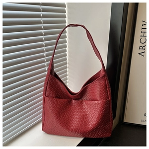 Detail shot of vintage dark red tote bag with premium crocodile pattern texture