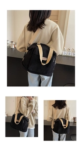 Detail view of black corduroy tote bag showing textured fabric and beige strap contrast