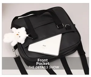 Detail of black crossbody bag front pocket showing spacious interior for a tablet