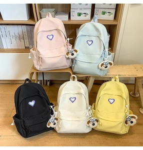 Collection of sweet minimalist backpacks in five colors with purple heart and dog charms