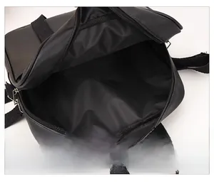 Internal view of black PU leather shoulder bag showing spacious main zipper compartment
