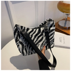 Detail of zebra print faux fur tote bag with adjustable strap and silver chain