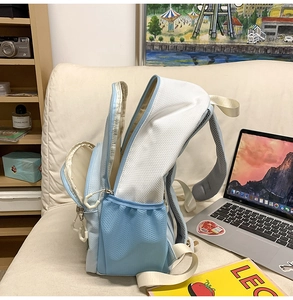 Detail view of breathable honeycomb mesh straps on light blue nylon backpack