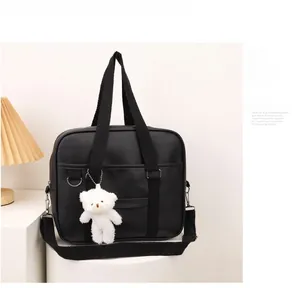 Black JK style PU leather handbag with white plush bear charm and adjustable strap