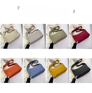 Collection of quilted puffer tote bags in eight vibrant colors with wide nylon straps