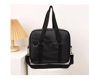 Detail of black Japanese style versatile crossbody bag with metal D-ring on white pedestal