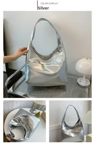 Detail view of large silver metallic hobo bag showing the texture and side angles