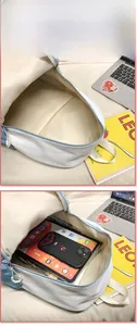 Interior view showing the large capacity of the nylon backpack holding a tablet and books