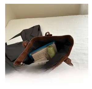 Top view of brown woven tote bag interior showing large capacity for umbrella and laptop