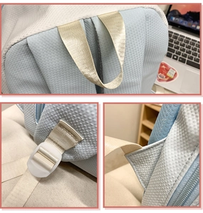 Detail view of water-resistant nylon backpack with reinforced straps and white buckles