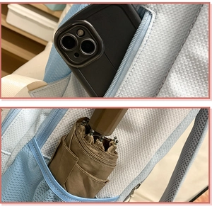 Detailed view of nylon backpack pockets showing smartphone storage and umbrella side pocket