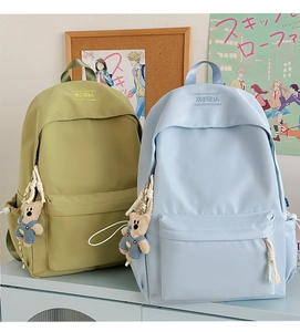 Light green and light blue minimalist nylon backpacks with cute teddy bear pendants