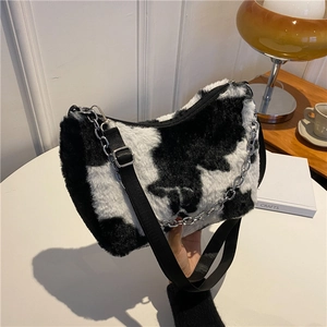 Furry cow print tote bag with silver chain and adjustable black strap for winter style