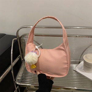 Minimalist light pink underarm bag with a cute plush duck charm and zipper closure
