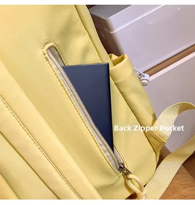 Detail view of the secure anti-theft back zipper pocket on this yellow nylon backpack
