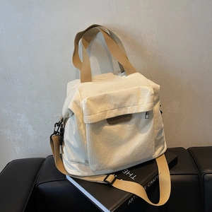 Minimalist corduroy tote bag in off-white with brown straps for winter fashion