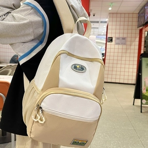 Beige and white nylon backpack for women with mesh texture and large capacity for travel
