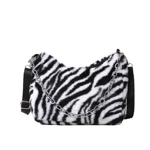 Faux fur zebra print tote bag with silver chain and adjustable shoulder strap for women