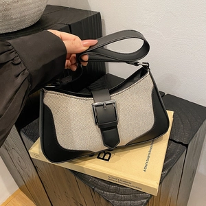 Minimalist canvas underarm bag with black leather trim and silver metal buckle