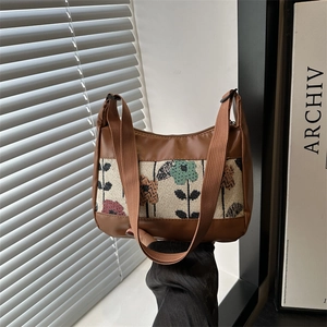 Chic floral tapestry and brown leather shoulder bag with adjustable strap and zip closure