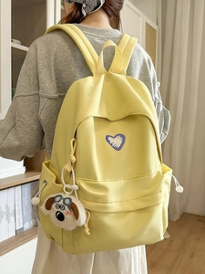 Bright yellow student backpack with heart embroidery and plush charm in casual style
