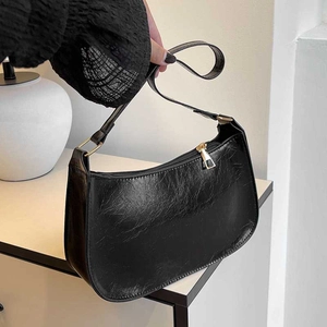Retro black leather baguette shoulder bag with gold zipper and textured finish