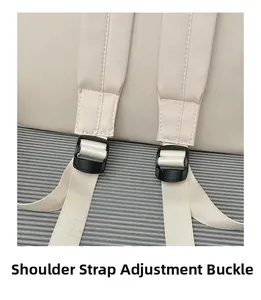 Detail of off-white backpack showing adjustable shoulder strap with black plastic buckle