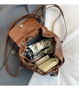 Detail view of the spacious interior of this vintage brown PU leather bucket backpack