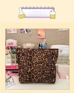 Close-up detail of oversized canvas tote bag with brown leopard print and square structure