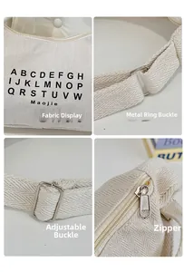 Detail view of herringbone canvas fabric with black lettering and metal hardware buckles