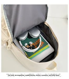 Spacious interior of beige minimalist backpack showing large capacity for laptop and books