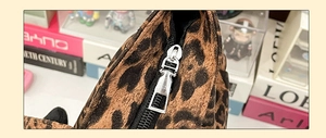Close-up of a leopard print tote bag featuring a high-quality silver metal zipper detail