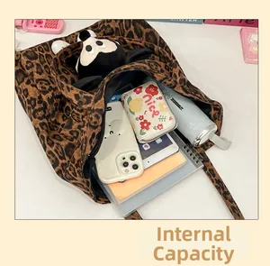 Internal view of the large capacity leopard print tote bag with daily essentials inside