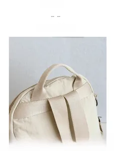 Close-up of comfortable handle and wide straps on cream travel backpack detail
