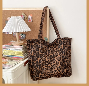 Close-up of leopard print tote bag with soft canvas texture and long handles for shoulder