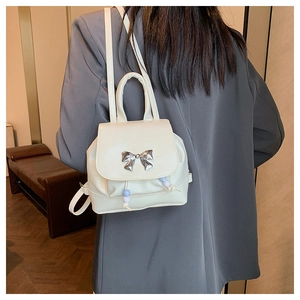Detail of white PU mini backpack with silver butterfly clasp and beaded drawstring